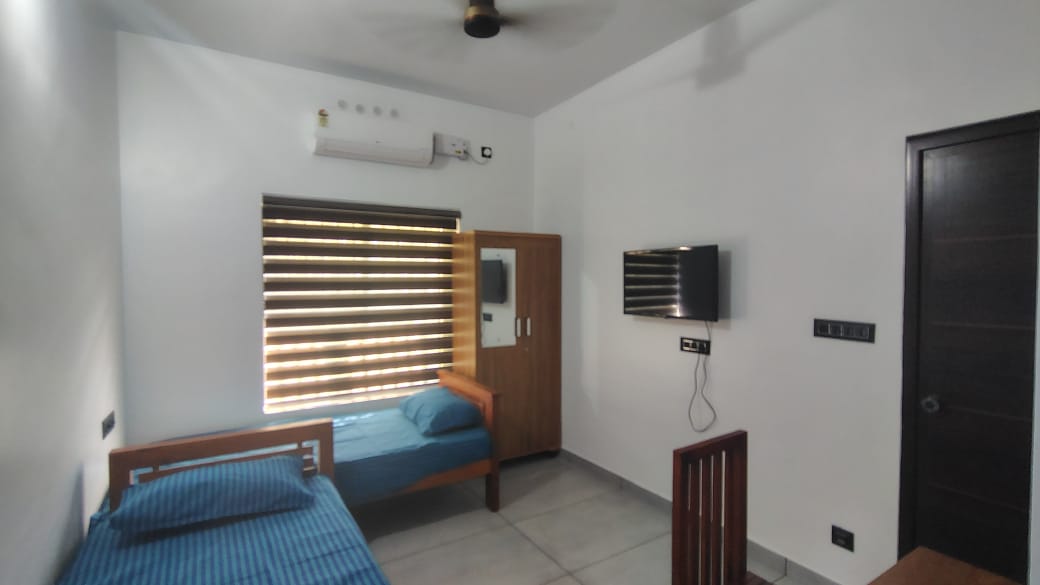 A second patient room, air-conditioned, with beds and a wardrobe